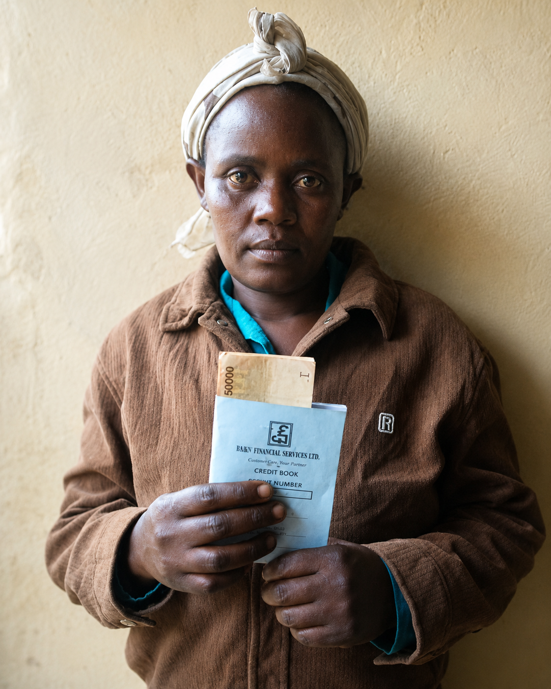 Woman group member holding disbursement materials
